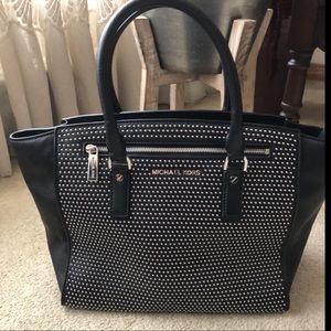 Authentic Michael Kors black grommet handbag.